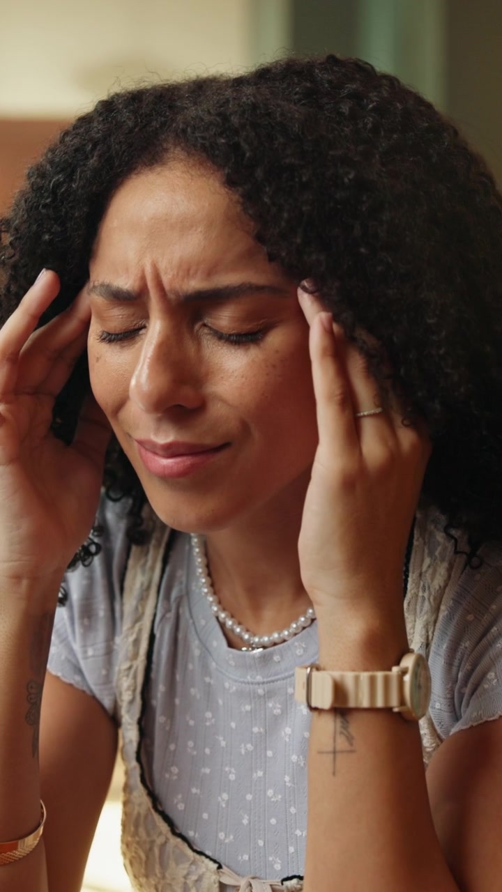 Stressed Young Woman Suffering from Headache While Working on Laptop