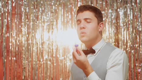 young man blowing soap bubbles