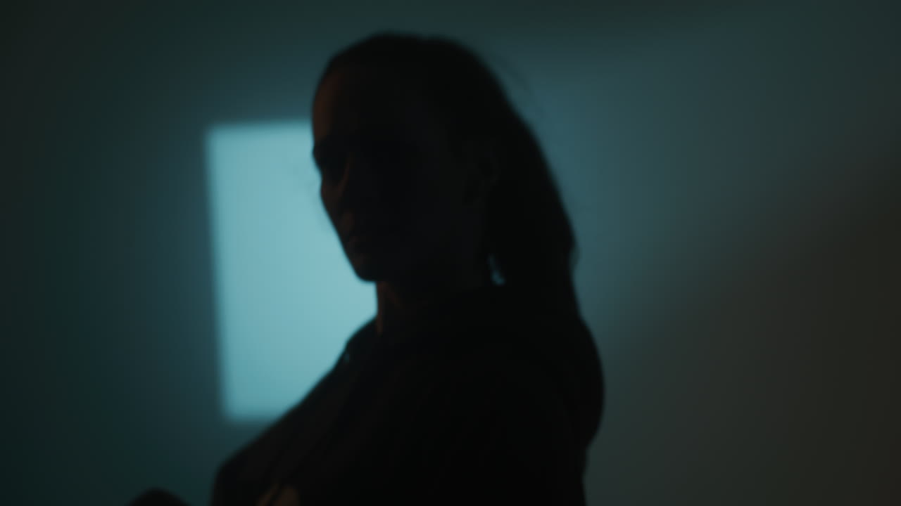 Woman Putting on Hoodie