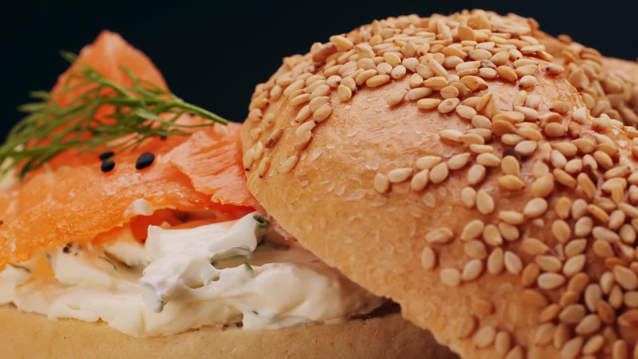 Bagel sandwich brunch, lunch plate of a bagel with smoked salmon and cream cheese and ham, close up morning cafe menu.