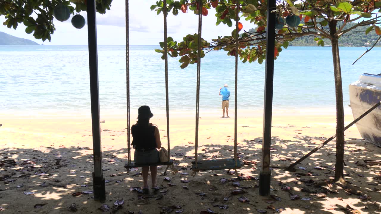 Peaceful swings at serene Klong Kloi Beach, Thailand, capturing solitude