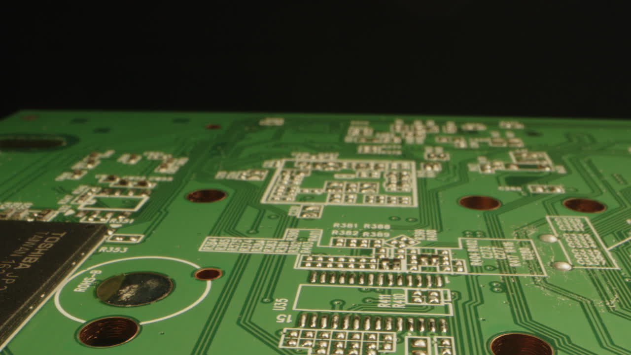 Beautiful macro of a circuit board with connections and microchips. The camera slowly moves over the printed board