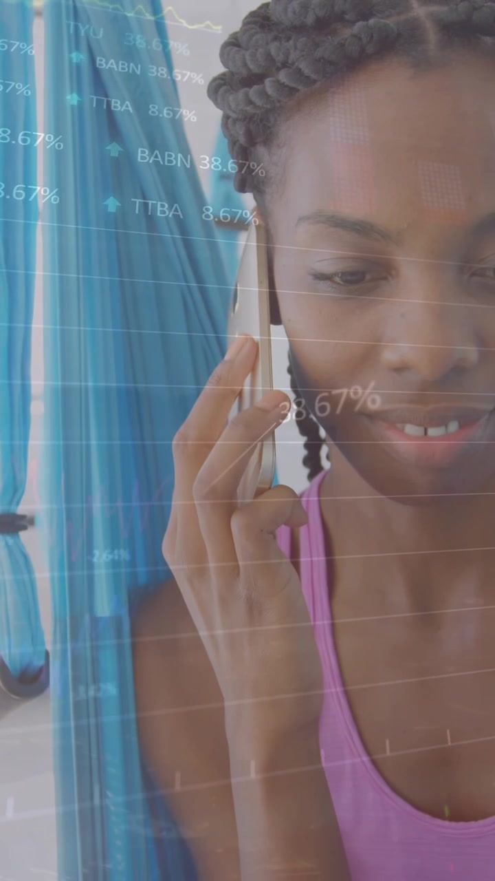 Animation of multiple graphs and trading boards, african american woman making call using cellphone