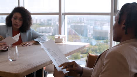 couple dining in modern restaurant with city view