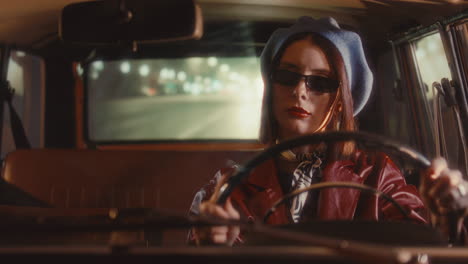 stylish girl in retro outfit driving through night