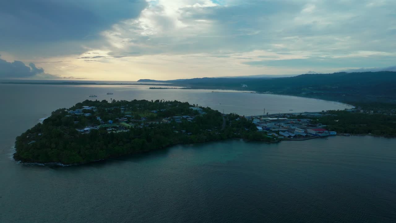 Wewak Papua New Guinea aerial drone PNG sunny clouds morning sunrise summer dry season Boram Road cape Wewak Hill costal town Wewak Seawall Port Dogreto Bay meni beach cargo vessel boats forward
