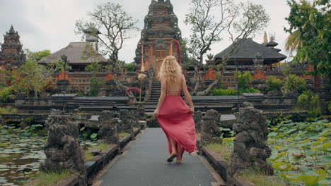 happy woman dancing in saraswati temple celebrating travel enjoying culture of bali indonesia 4k