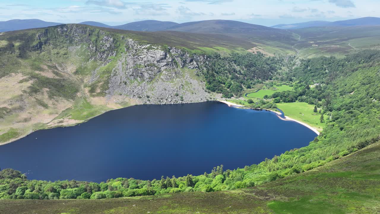 Ireland Epic Locations drone rising to reveal stunning Lough Tay In The Wicklow Mountains Ireland in summer