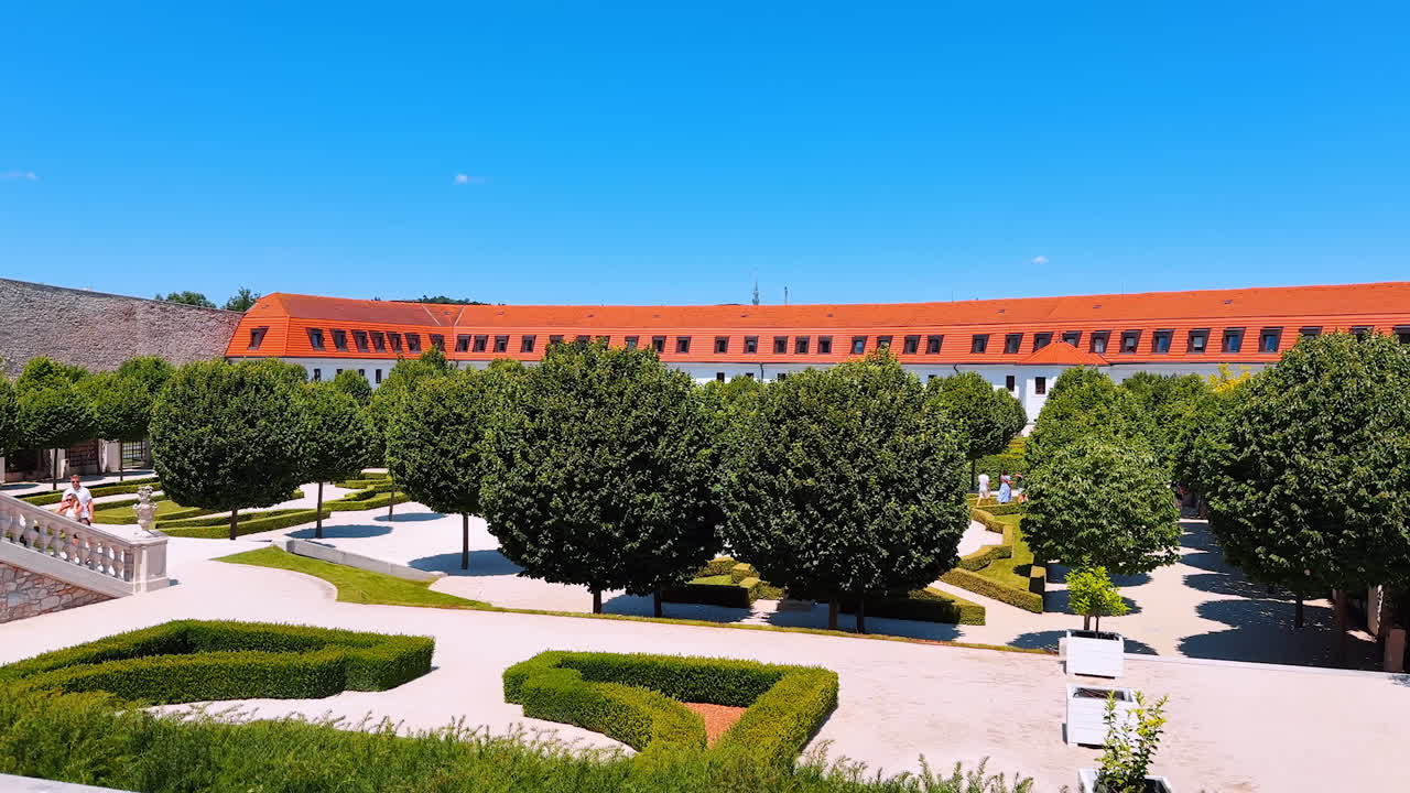 Beautiful garden with neatly cut trees in the courtyard of the old castle. Territory of the Bratislava Castle in Slovakia