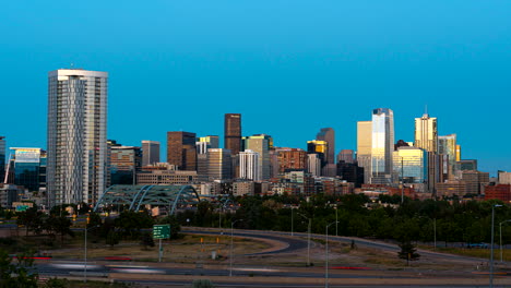 dynamic day to night motion time-lapse of traffic and illuminated denver skyline