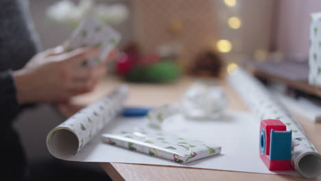close up of woman assembling wrapped presents for gifting them on christmas