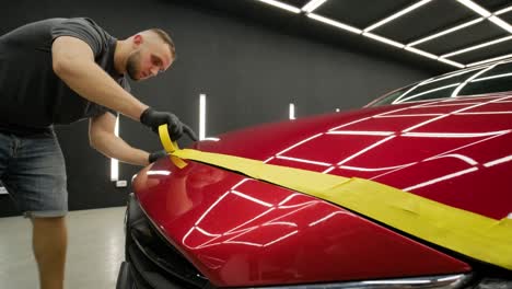 headlight polishing, processing of car lights. a car service worker polishes the headlight of a passenger car. professional polishing.