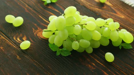 Grapes-on-branch-on-dark-table-