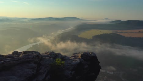 foggy sunrise in the elbe sandstone mountains, saxon switzerland, germany