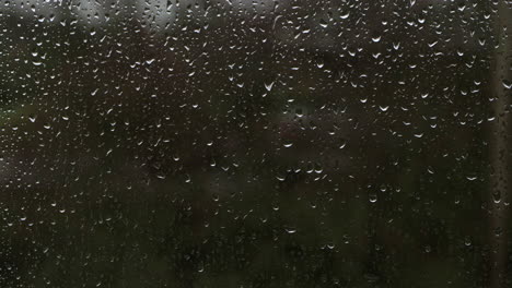 Closeup-timelapse-of-bad-weather-with-Raindrops-rain-on-glass-surface-window,-in-4k-30p-10bit-Apple-ProRes422