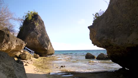 oslob, cebu, philippines - a picturesque coastline featuring rock formations on a warm summer day - static shot
