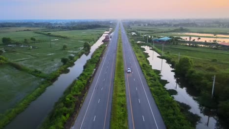 Aerial-drone-shot-of-fast-cars-on-highway-road-in-nature-of-Thailand