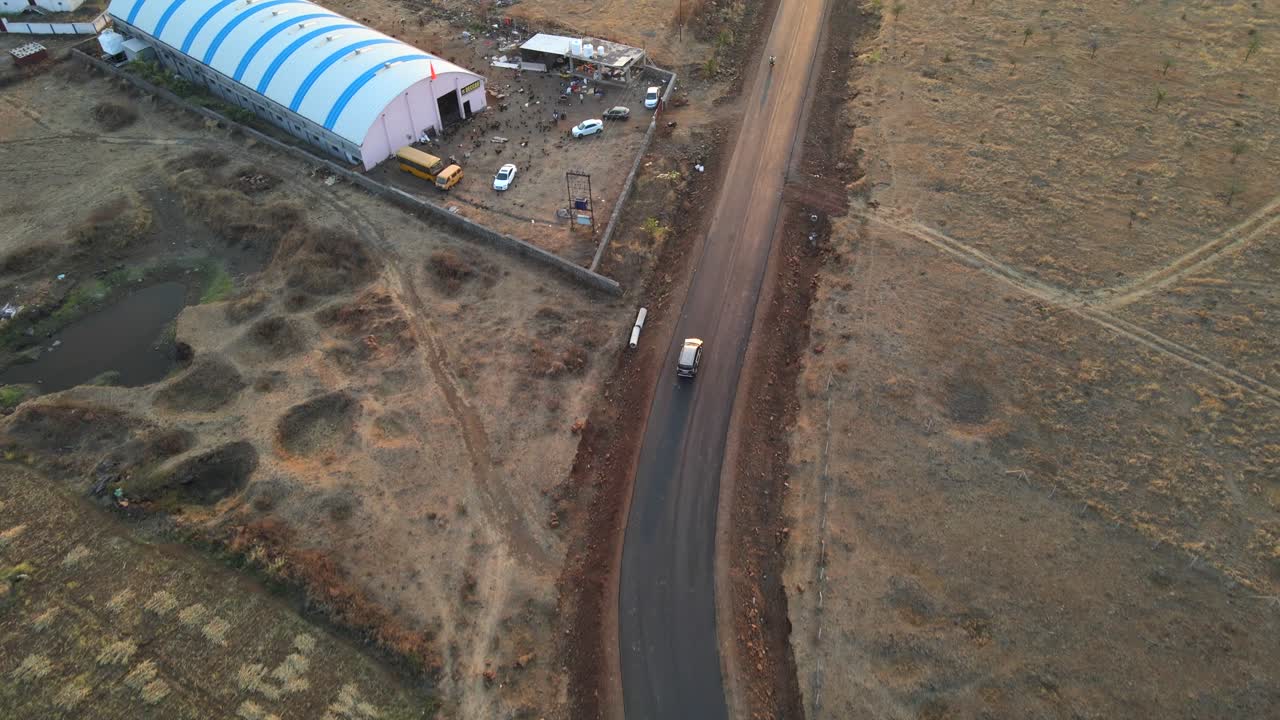 drone following Inova car from top in rural village farm road cinematic in sunset sunrise Maharashtra india osmanabad india ter long shadow sunset