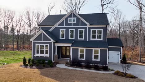 Panning-Left-On-The-Exterior-Of-A-Luxury-Grey-Home,-Aerial-Video