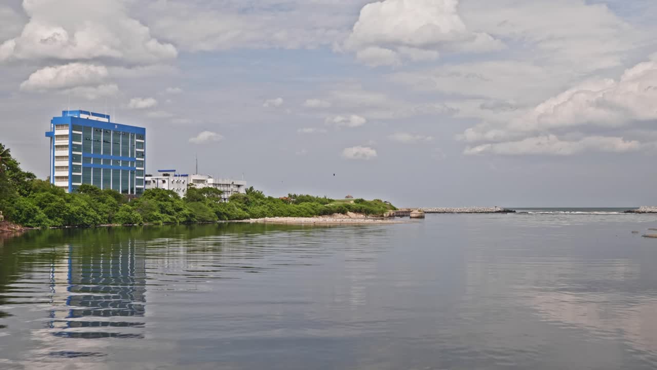 cooum river with Indian Coast Guard Regional Headquarters and clouds near marina beach, triplicane, chennai, tamil nadu, india. day time, stable shot, 4k.