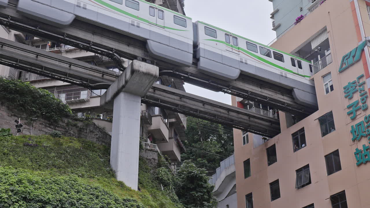 CHONGQING, CHINA - 28 MAY 2025 : train enters liziba station inside a building on bridge in Chongqing china