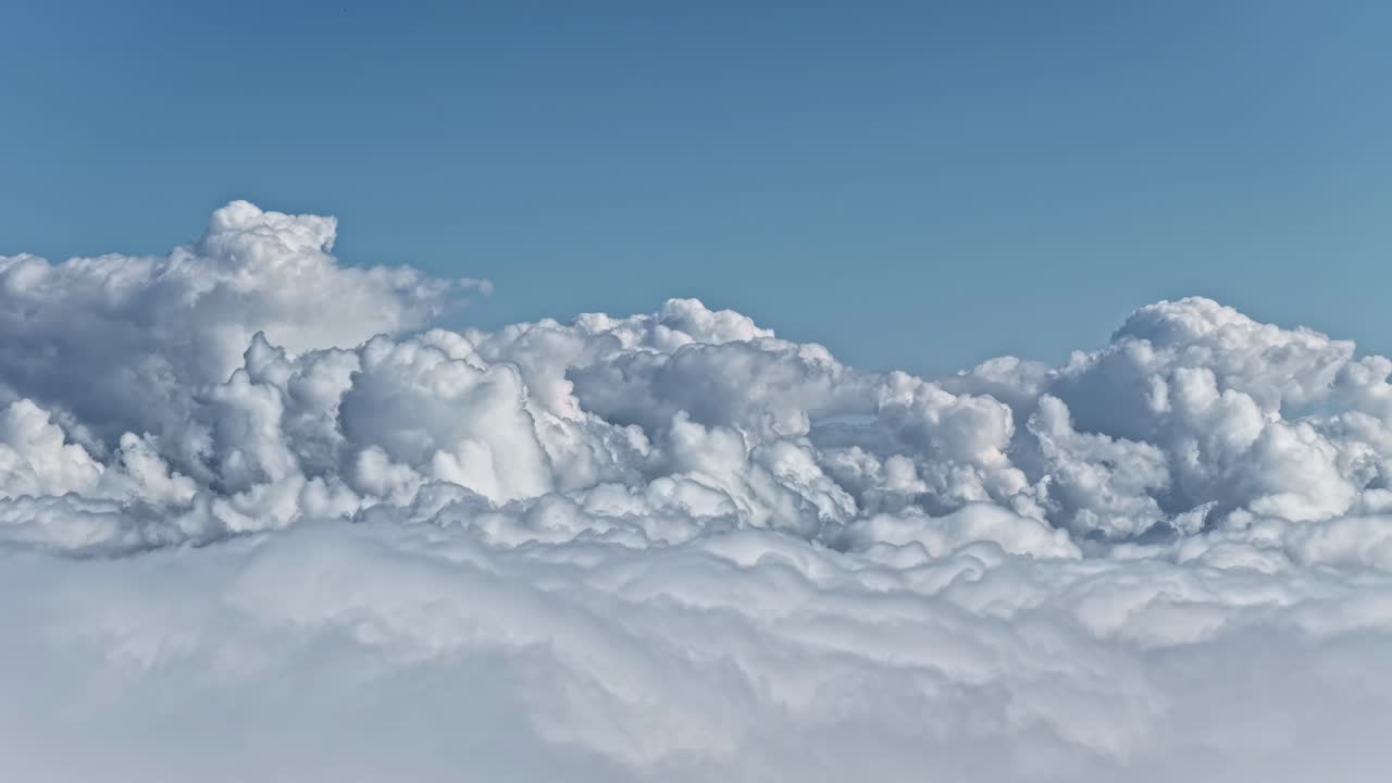 Cumulonimbus clouds high altitude aerial plane window view atmosphere