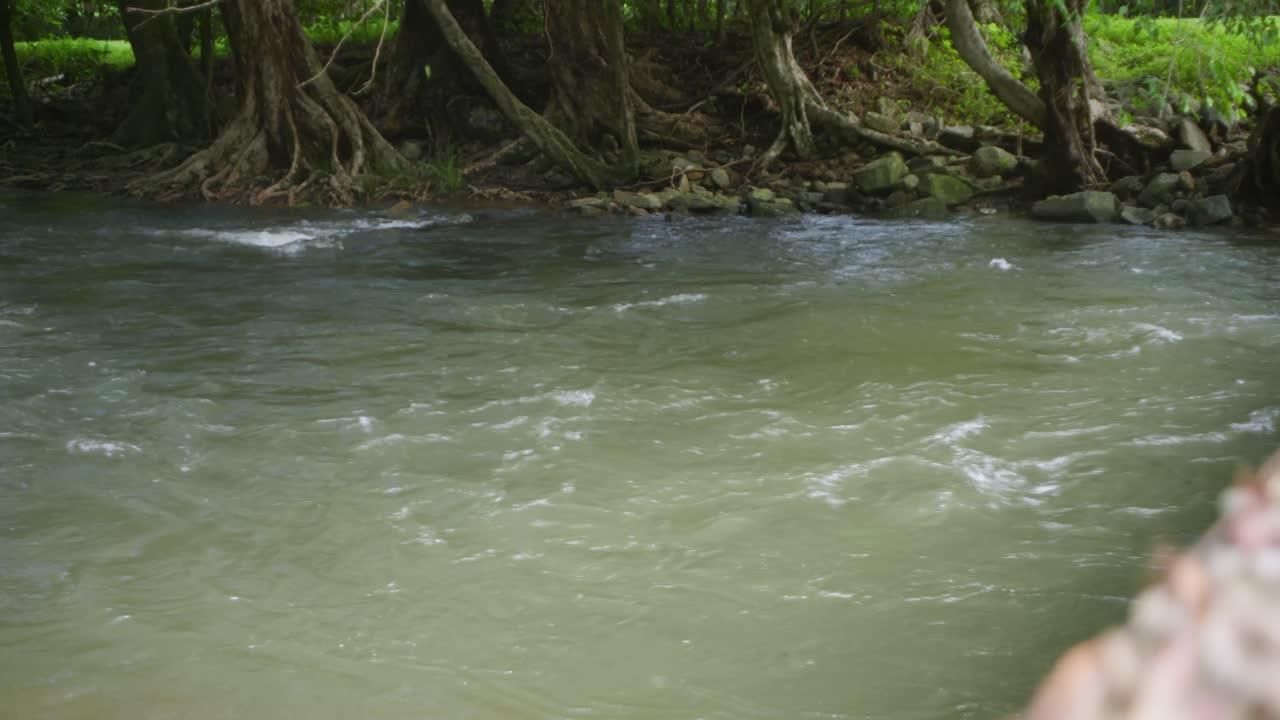 A flowing river in tropical suburban Australia. Clip 3