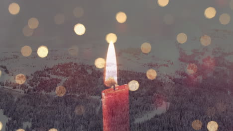 composición digital de una vela ardiente y puntos de luz contra el paisaje de nieve