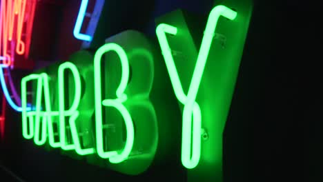 close shot of green neon in a dark room in slow motion