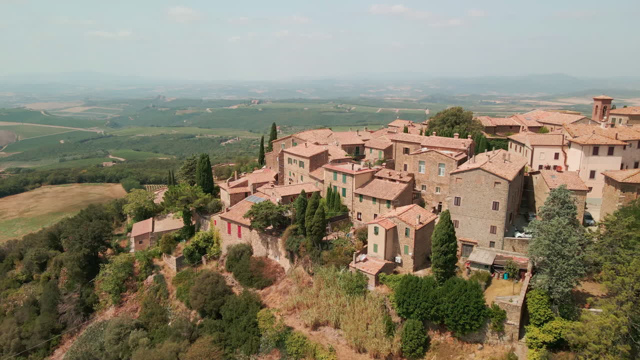 asentamiento histórico en un acantilado con exuberantes tierras de cultivo en el fondo en sant'angelo in colle, montalcino siena, toscana, italia central