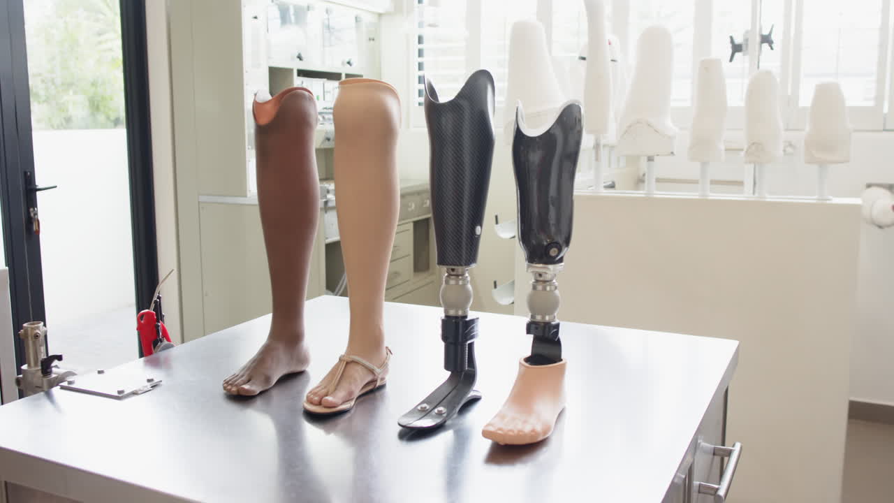 Prosthetic legs displayed on table in laboratory, showcasing different designs