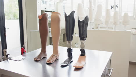 prosthetic legs displayed on table in laboratory, showcasing different designs