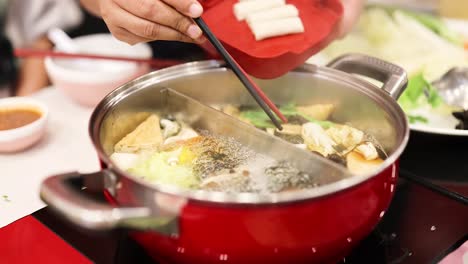 preparing hotpot with fresh ingredients in bangkok