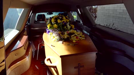 closeup shot of a funeral casket in a hearse or chapel or burial at cemetery