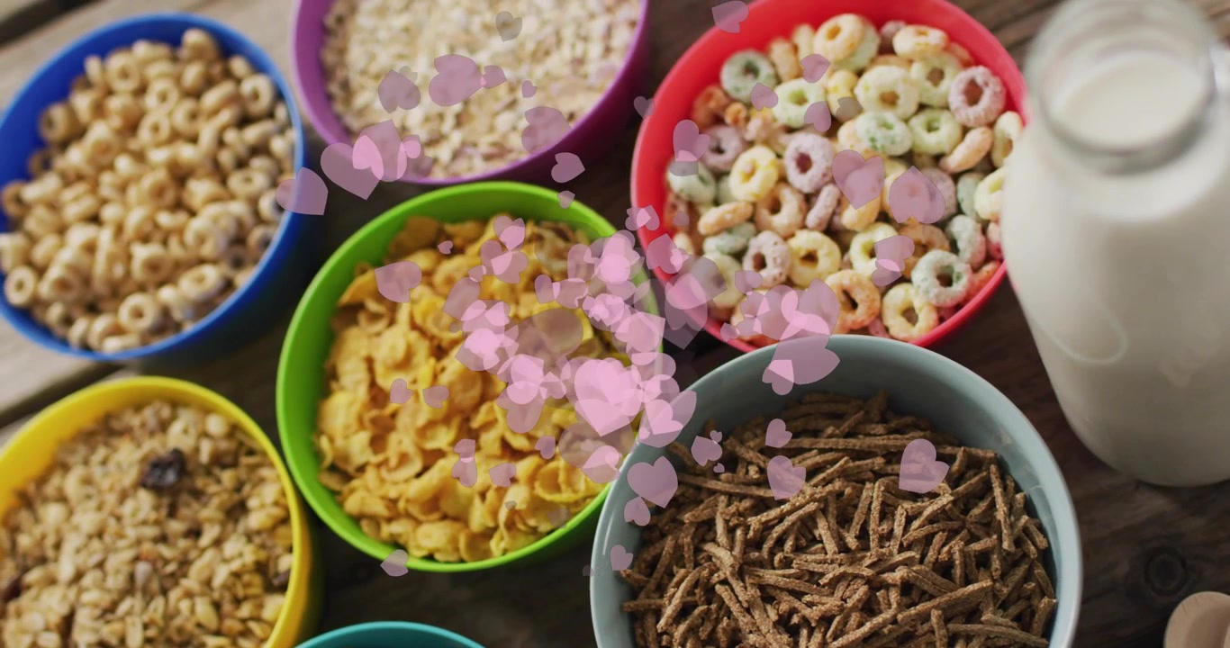 Pink hearts appearing at center, drifting across cereal bowls and milk bottle, adding playful charm