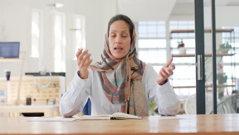 portrait of busy biracial businesswoman having video call in slow motion