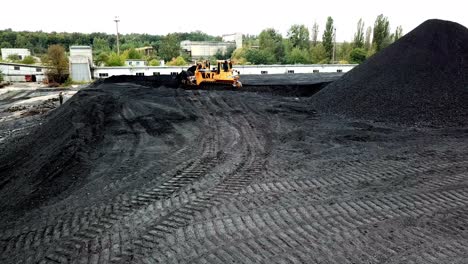 coal handling operations at the factory. crawler bulldozer works. aerial view.