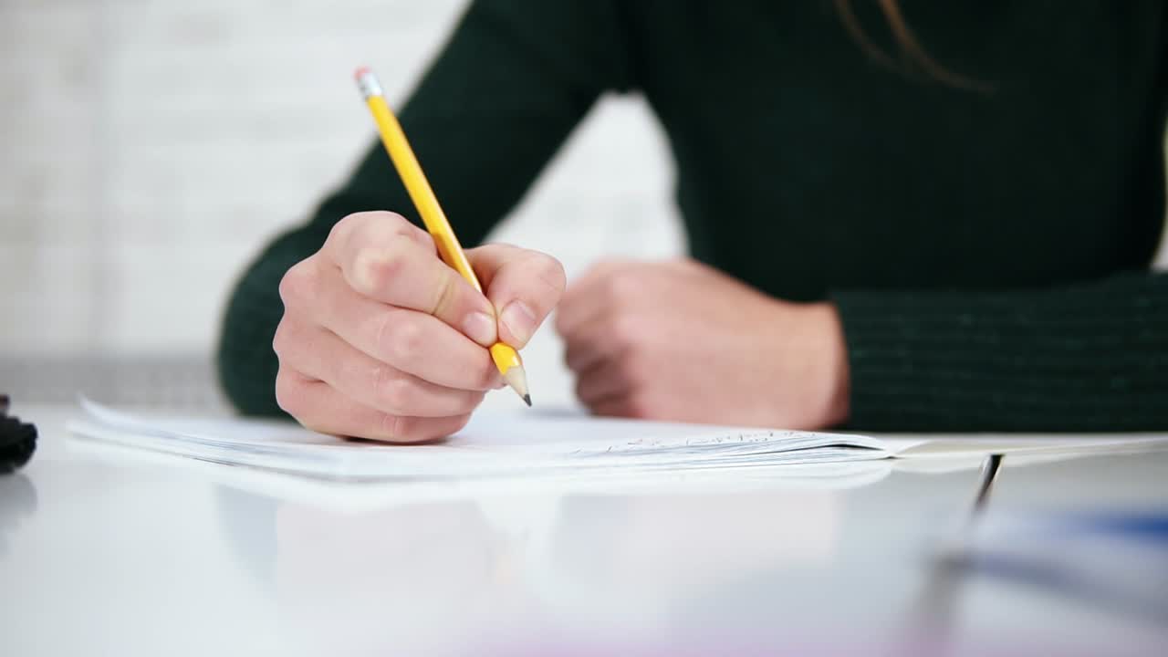 Human woman's hands with pencil writing erase and rewrite words