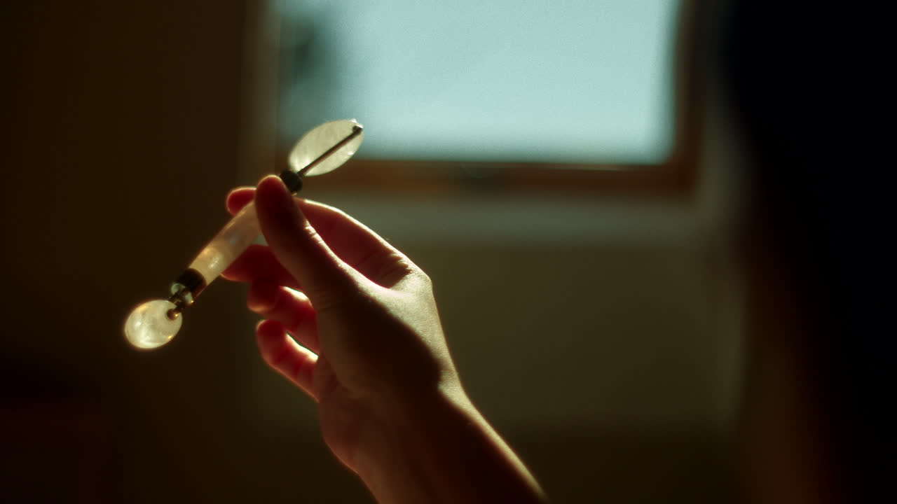 Woman using a jade facial roller