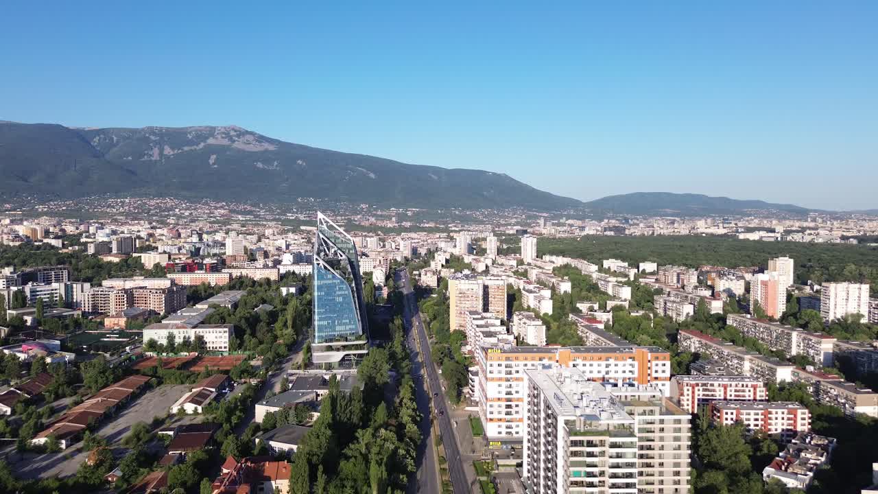 Aerial cityscape of Sofia, Bulgaria. Vitosha mountain in the background on a sunny day with a clear blue sky. Drone sho of an East European capital city with a mix of old and modern buildings