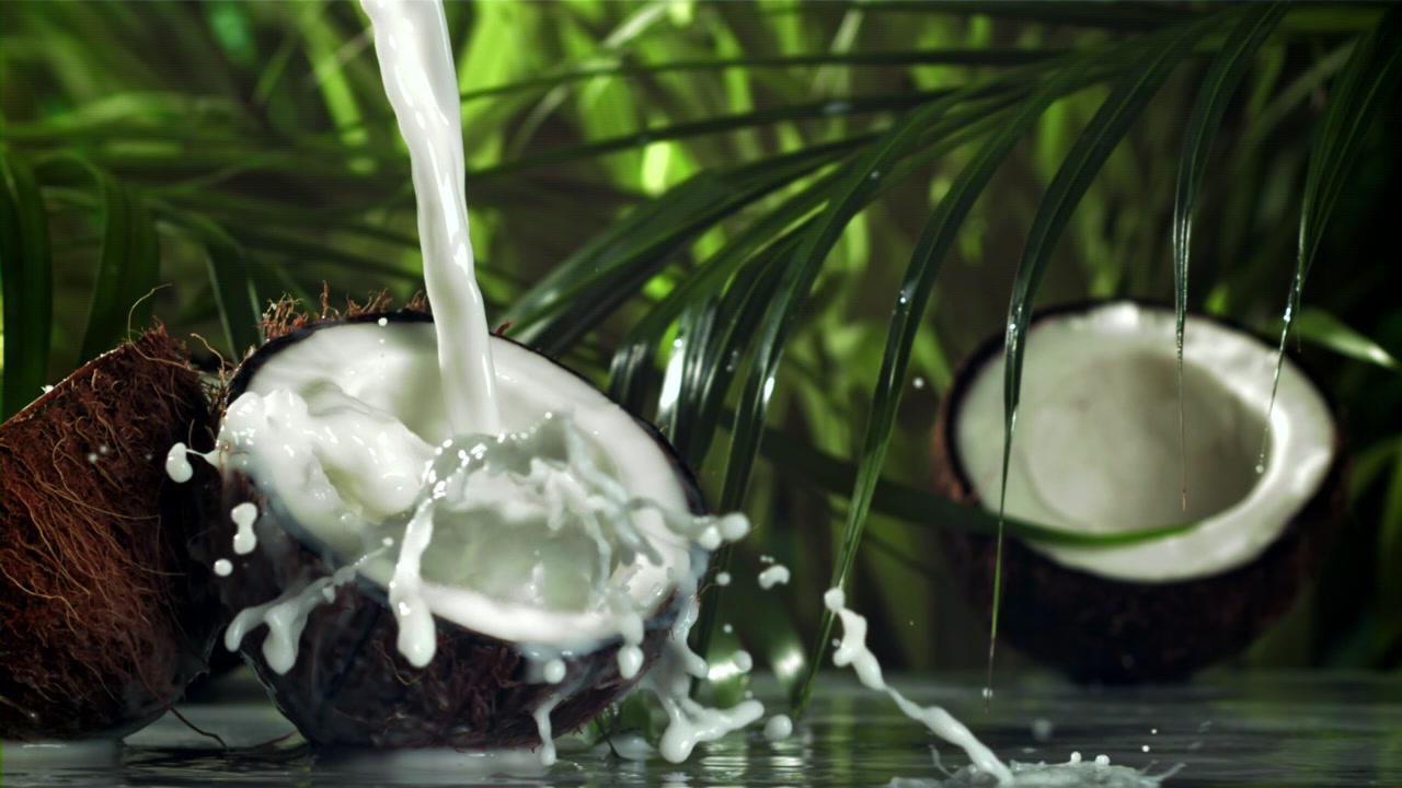 Slow Motion Pour of Coconut Milk into a Fresh Coconut