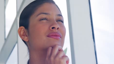 contemplating-woman-looking-out-office-window