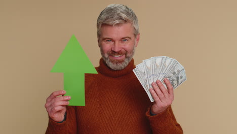 man holding money and a green up arrow