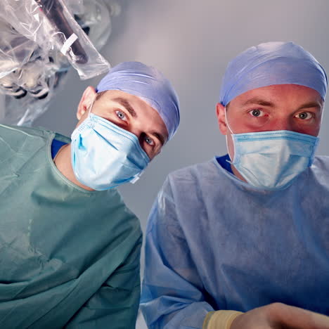 surgeons working in operating room. discussing medical issues.