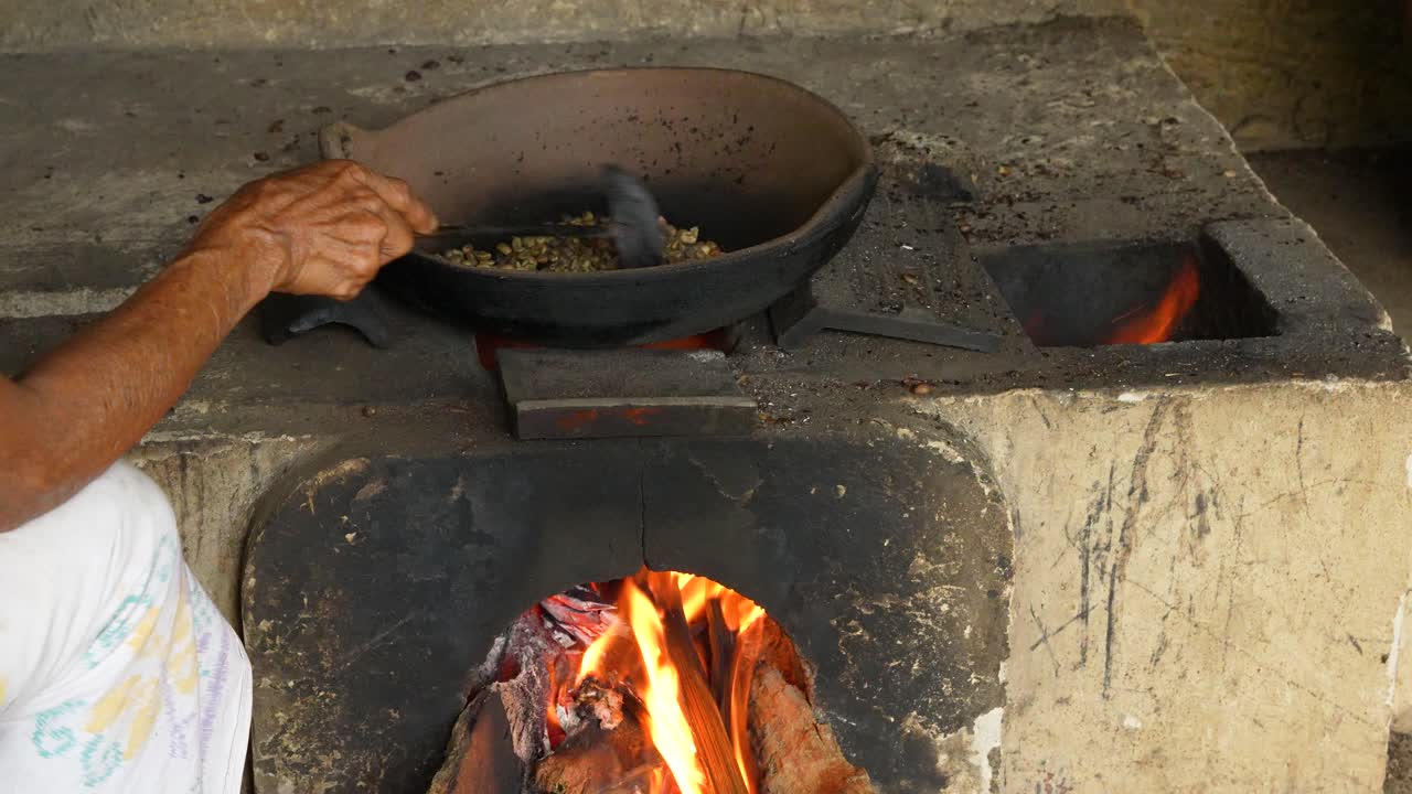 Iron pan on open flame used to roast traditional coffee beans in Bali Indonesia