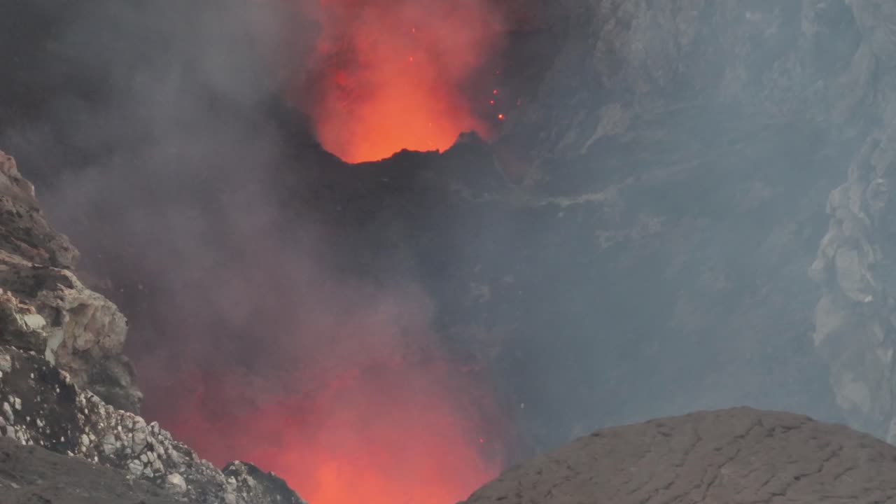 Explosion of lava and gas, geothermal reaction in active volcano eruption, drone close up. Mount Yasur