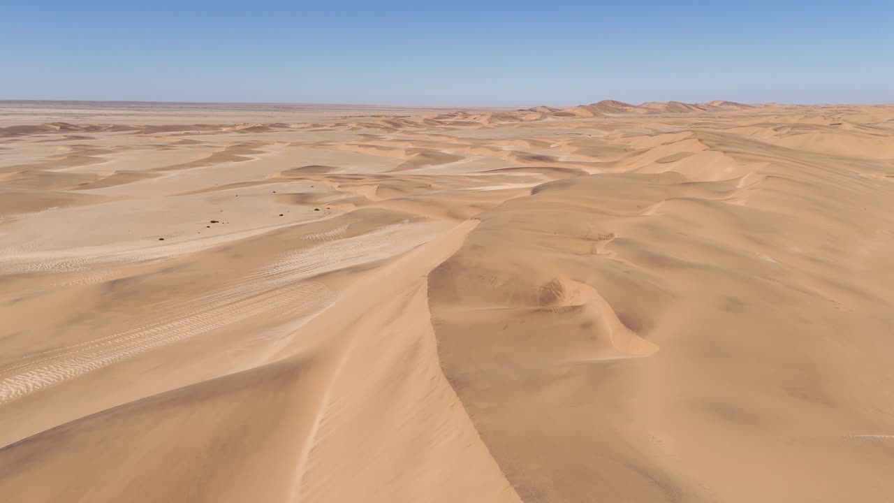 Drone view over the vast Namib Desert dunes, with soft shadows by the coastal winds of Swakopmund, Namibia
