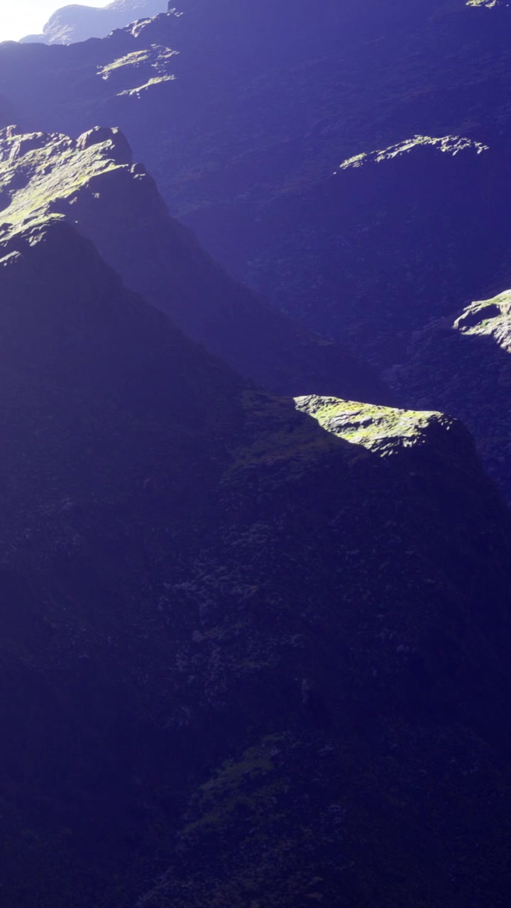 Majestic mountain ranges bathed in twilight shadows near the valley
