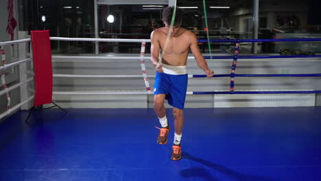 boxer jumping rope in boxing ring