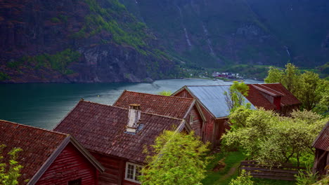 Rooftops-of-small-old-township-near-mountain-lake,-time-lapse-view